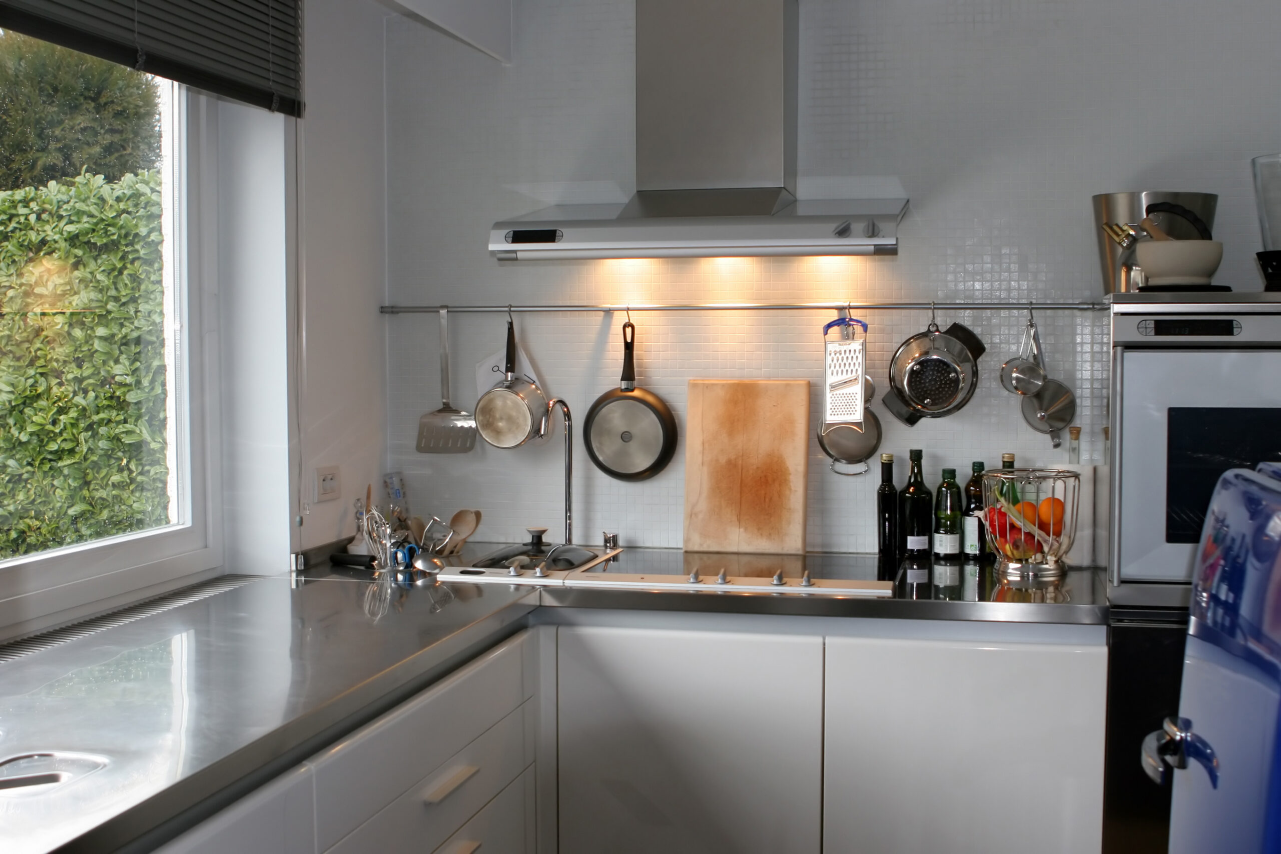 Hang pots above the stove with a ceiling-mounted rack for both style and convenience.