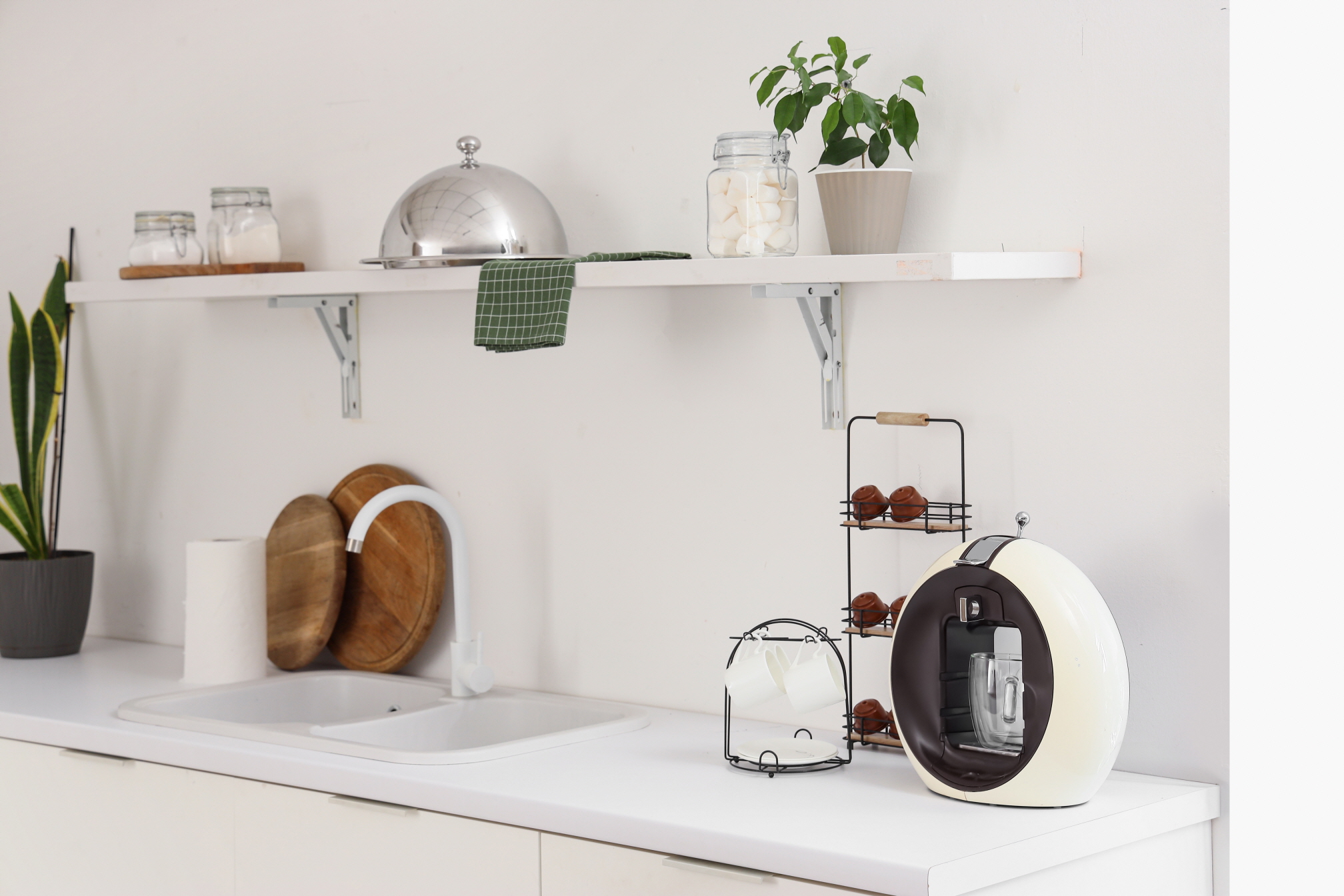 Open shelving appears less bulky compared to traditional cabinets, making the kitchen look more spacious.
