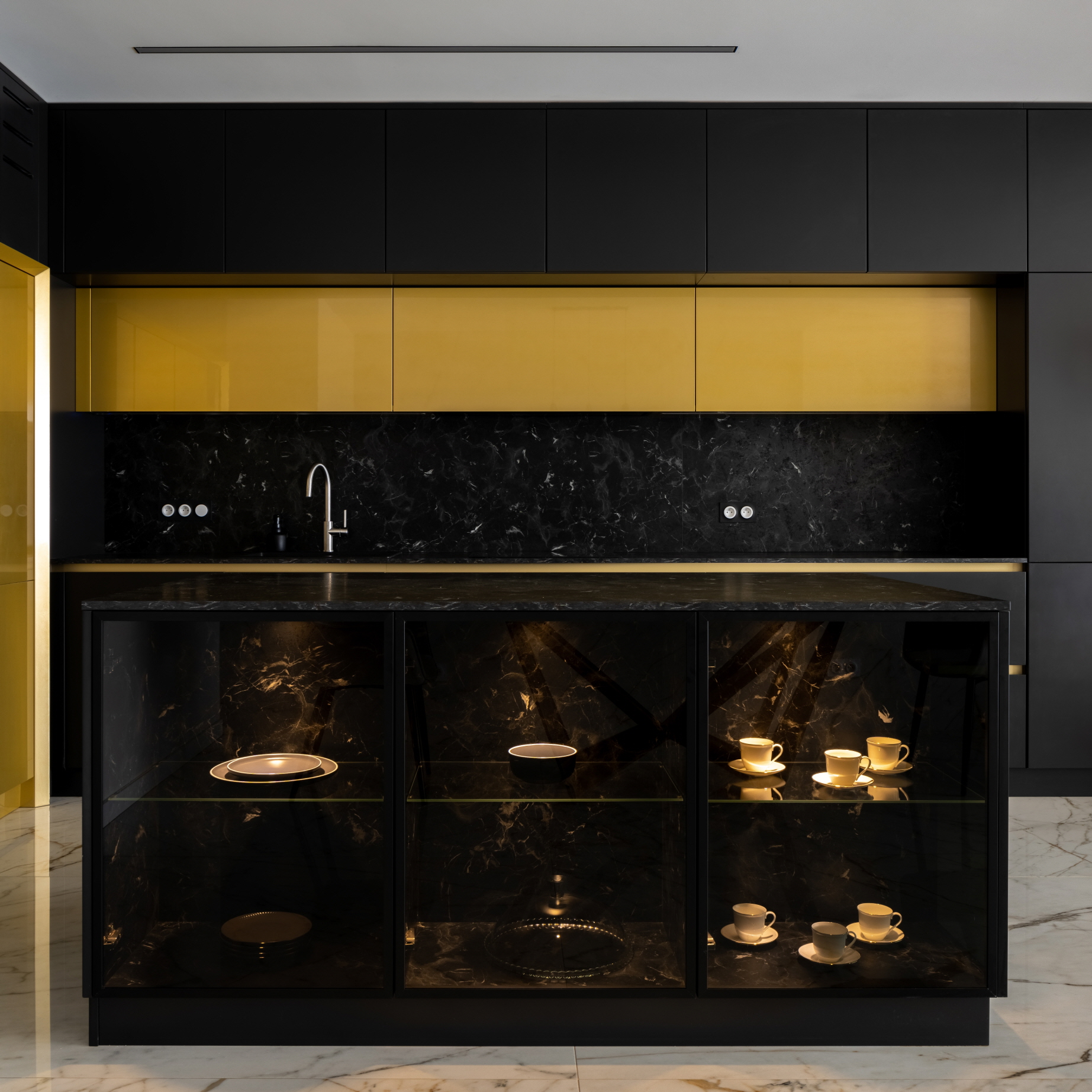 An elegant combination of black countertops and gold accents enhances the appeal of your kitchen.